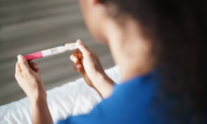 woman with pregnancy test
